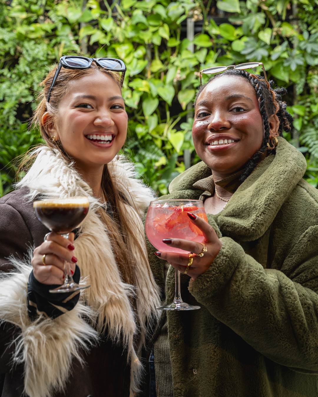 Two girls and their drinks photography at an event in San Francisco captured by a professional photographer.