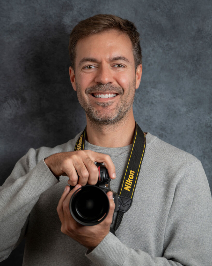Portrait of Rodrigo Cavassoni, food photographer in San Francisco, holding his camera